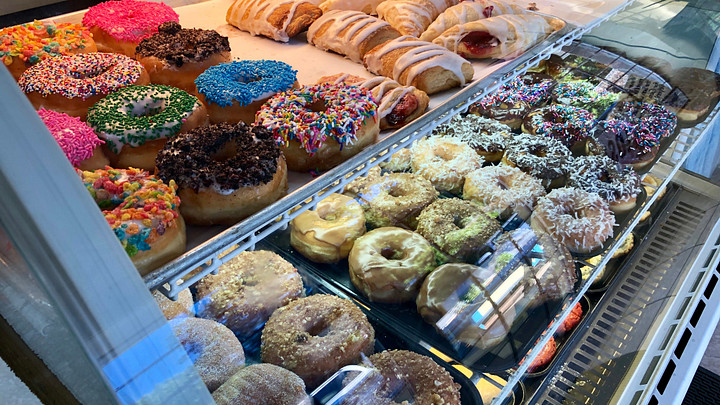 donuts at a bakery behind glass