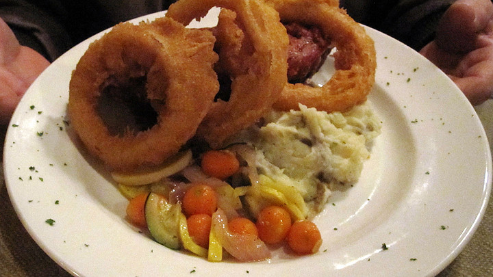 Dish with vegetable medley, mashed potatoes, onion rings