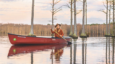 woman kayaking cypress swamp