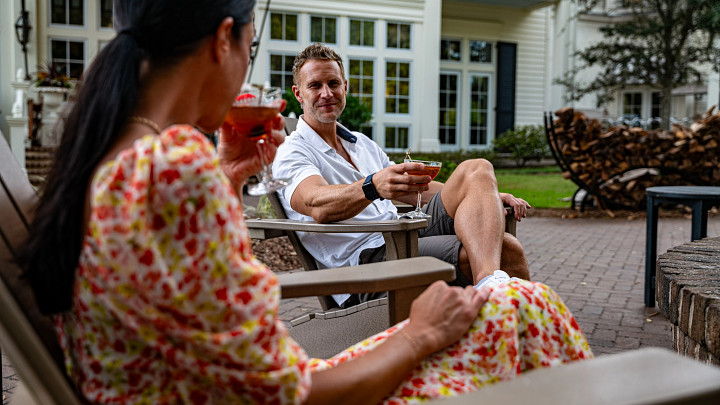 couple sitting outside enjoying a cocktail