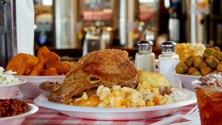 plate with meatloaf, fried fish, turnip greens, macaroni and cheese, fried okra, creamed corn